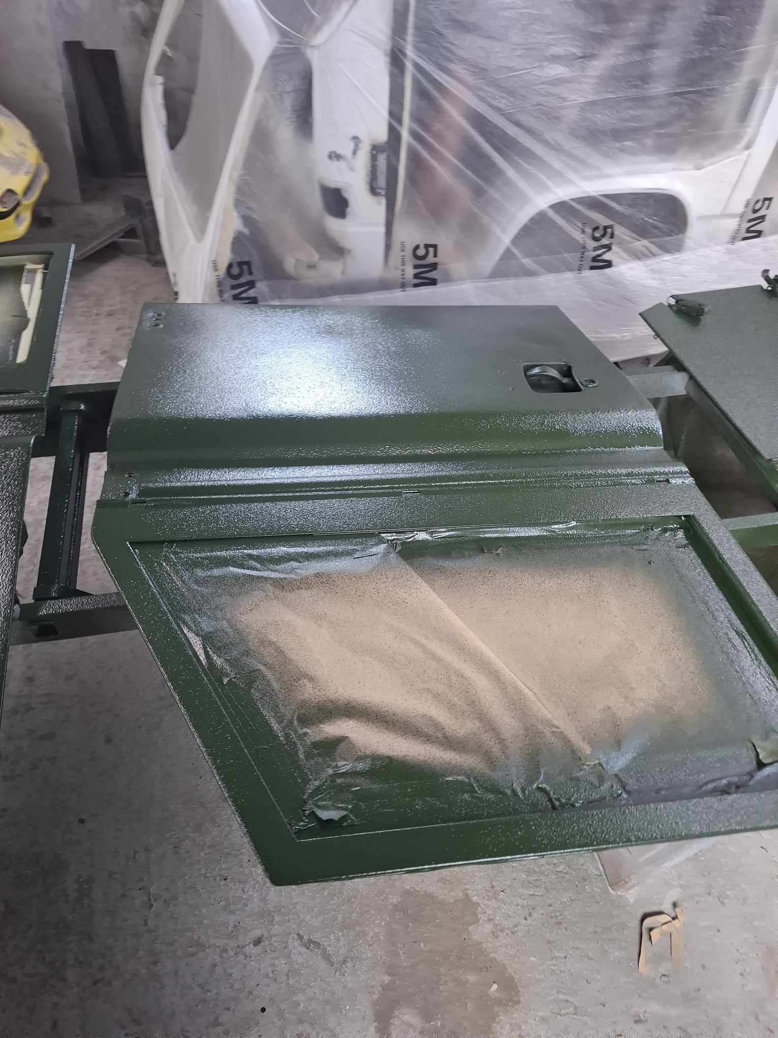 Land Rover panel finished in green Raptor coating with practical finish
