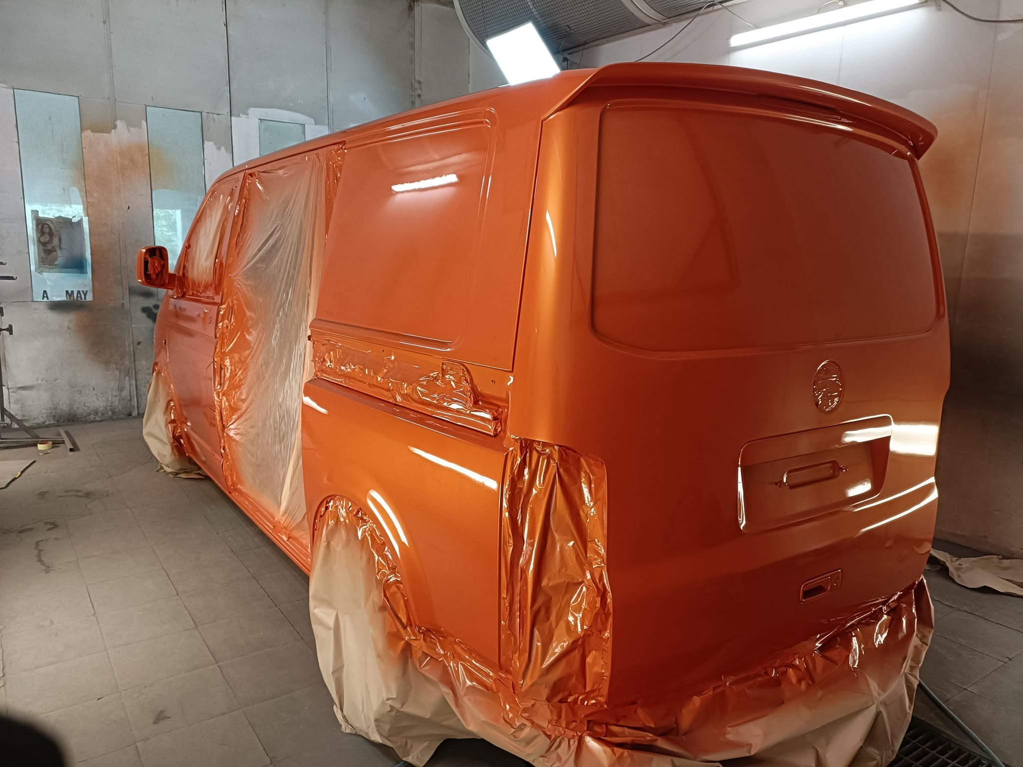 Orange VW Transporter rear quarter prepared for final topcoating